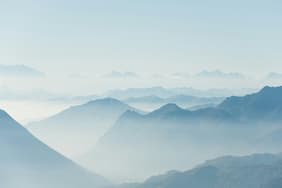 Blue misty mountains.  Photo by Alessio Soggetti on Unsplash.